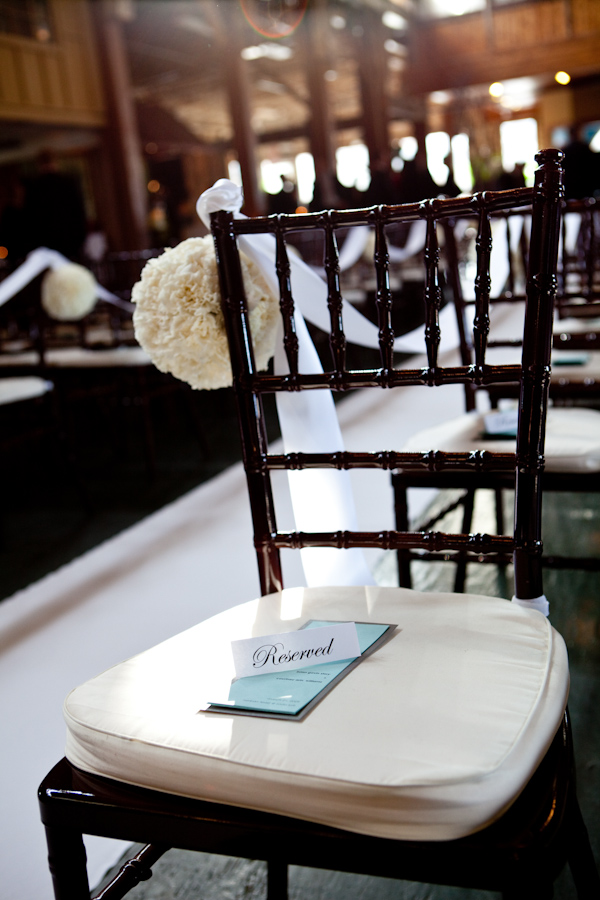 color photo of ceremony seating details - ivory seat covers - photo by Seattle based wedding photographers La Vie Photography
